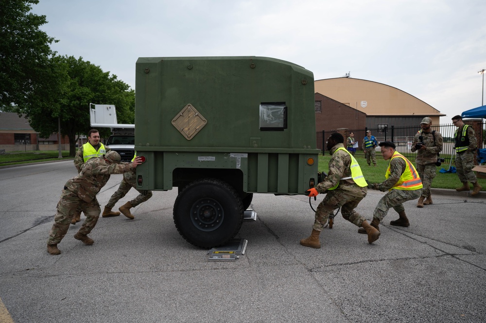 Airmen from the 375th Air Mobility Command push a humvee carriage during Cardinal Strike