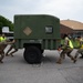 Airmen from the 375th Air Mobility Command push a humvee carriage during Cardinal Strike