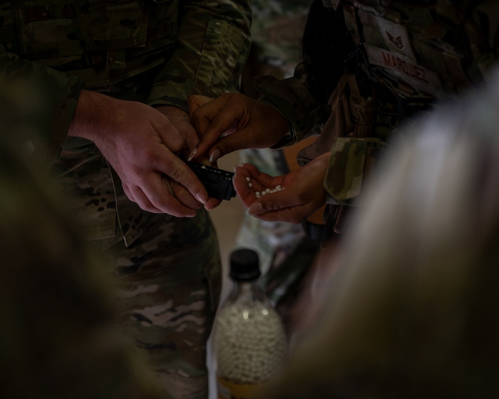 932nd airmen prepare and load magazines during breaching and entering movements.