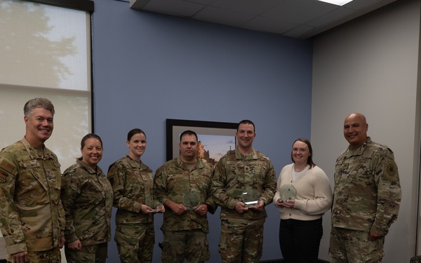 Quarterly Awards winners accept their award.