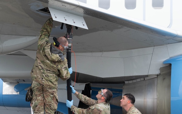 QLLEX participants assists in refueling a C-40