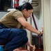 USS Ronald Reagan (CVN 76) Sailors and contractors conduct deck refinishing