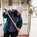 USS Ronald Reagan (CVN 76) Sailors and contractors conduct deck refinishing