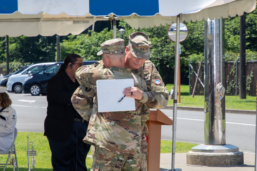 Maj. Gen. Dave Womack relinquishes command of U.S. Army Japan to Brig. Gen. James Dooghan, as Gen