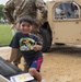 A young boy gives a thumbs up after getting into a High Mobility Multipurpose Wheeled Vehicle (HMMWV) at the 250th U.S. Army Birthday Festival