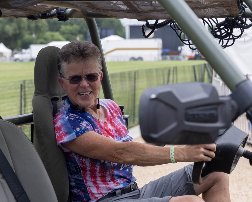 A woman smiles while in the driver's seat in one of the many vehicles featured at the 250th U.S. Army Birthday Festival
