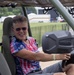 A woman smiles while in the driver's seat in one of the many vehicles featured at the 250th U.S. Army Birthday Festival