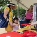 A little girl wins a free frisbee after spinning a prize wheel at the 250th U.S. Army Birthday Festival
