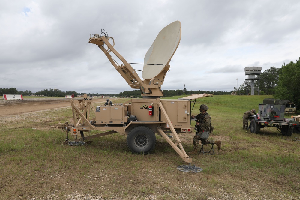 Soldier works on satellite communications at JRTC