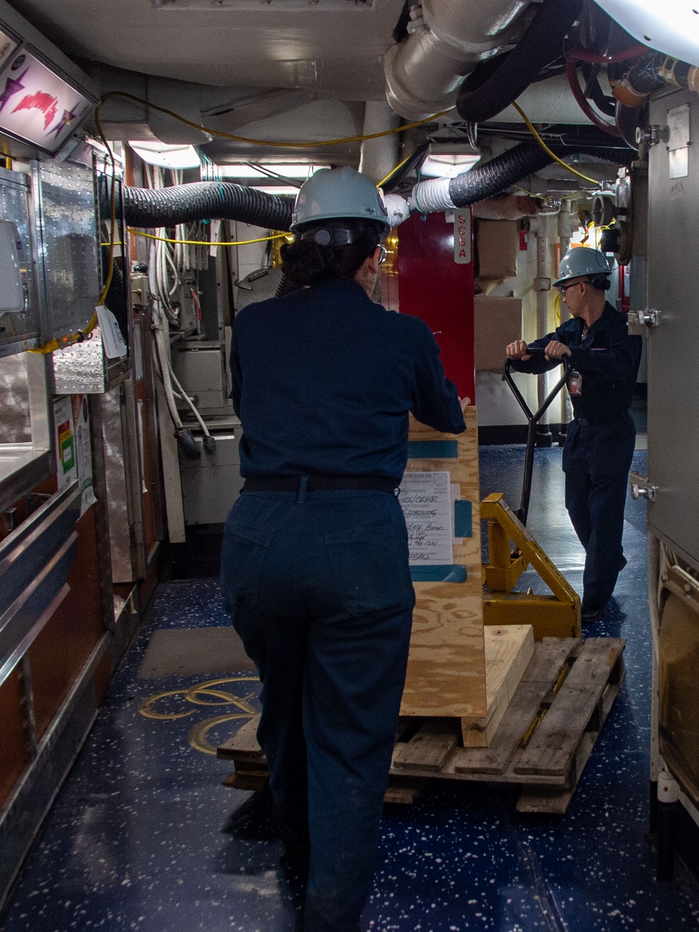 USS Ronald Reagan (CVN 76) Sailors Move Pallets Through Mess Decks