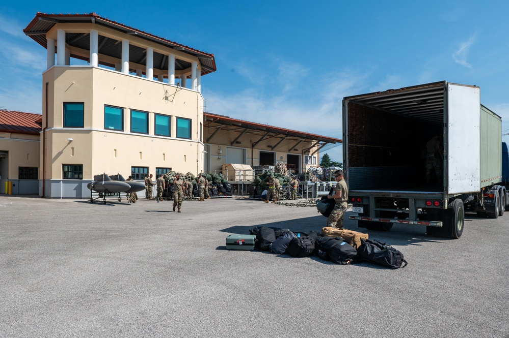 Airmen offload luggage at Aviano Air Base, Italy