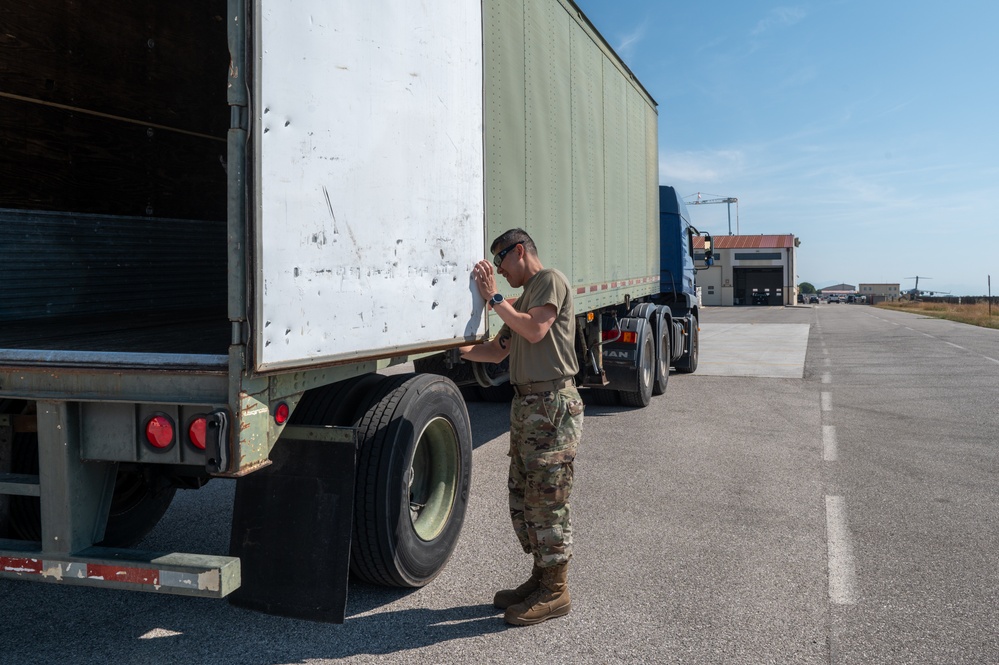 Airmen offload luggage at Aviano Air Base, Italy