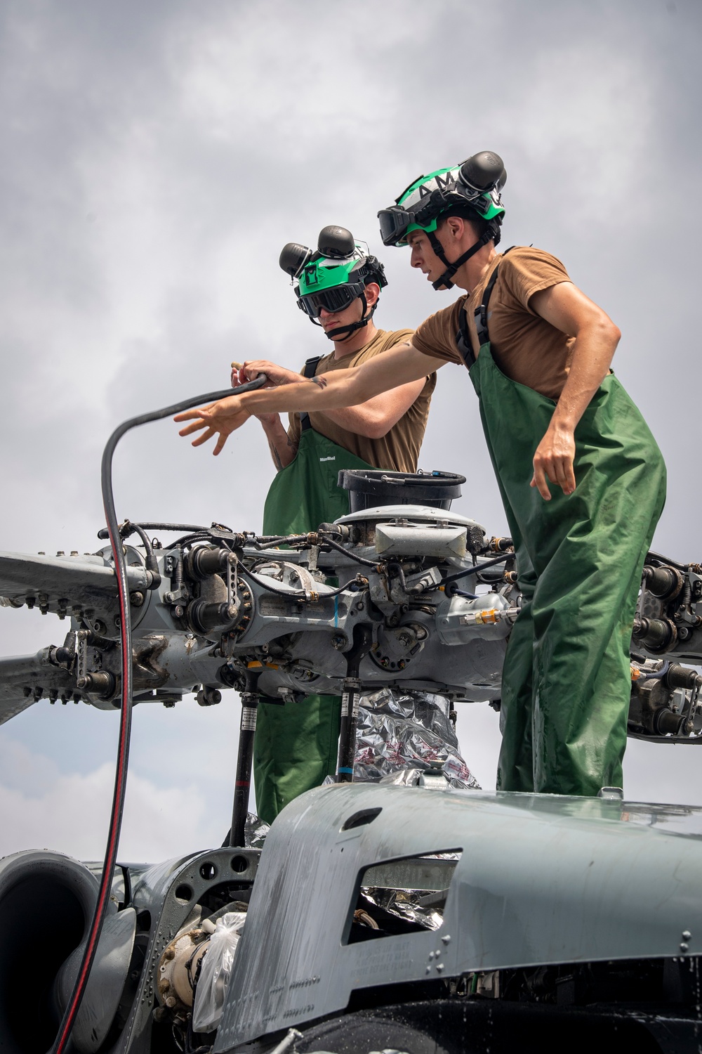 Sailors wash helicopter