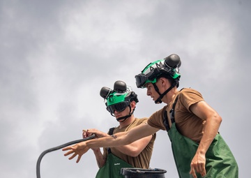 Sailors wash helicopter