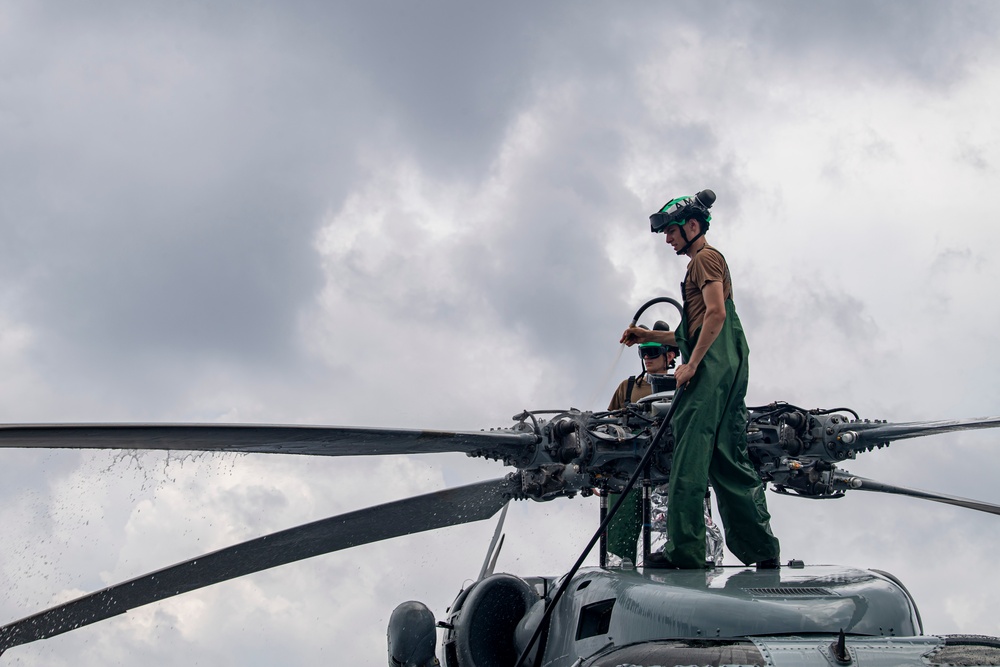 Sailors wash helicopter