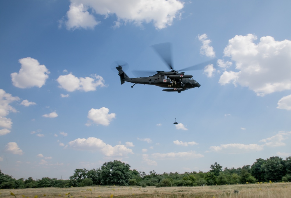 12th Combat Aviation Brigade Soldiers conduct MEDEVAC hoist training with a UH-60 Black Hawk helicopter