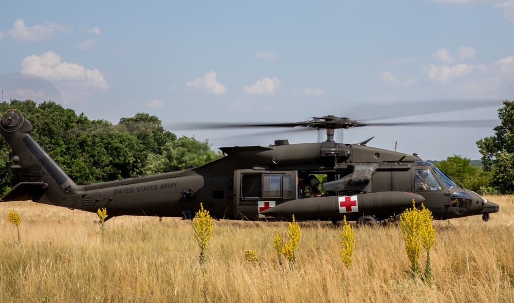 12th Combat Aviation Brigade Soldiers conduct MEDEVAC hoist training with a UH-60 Black Hawk helicopter