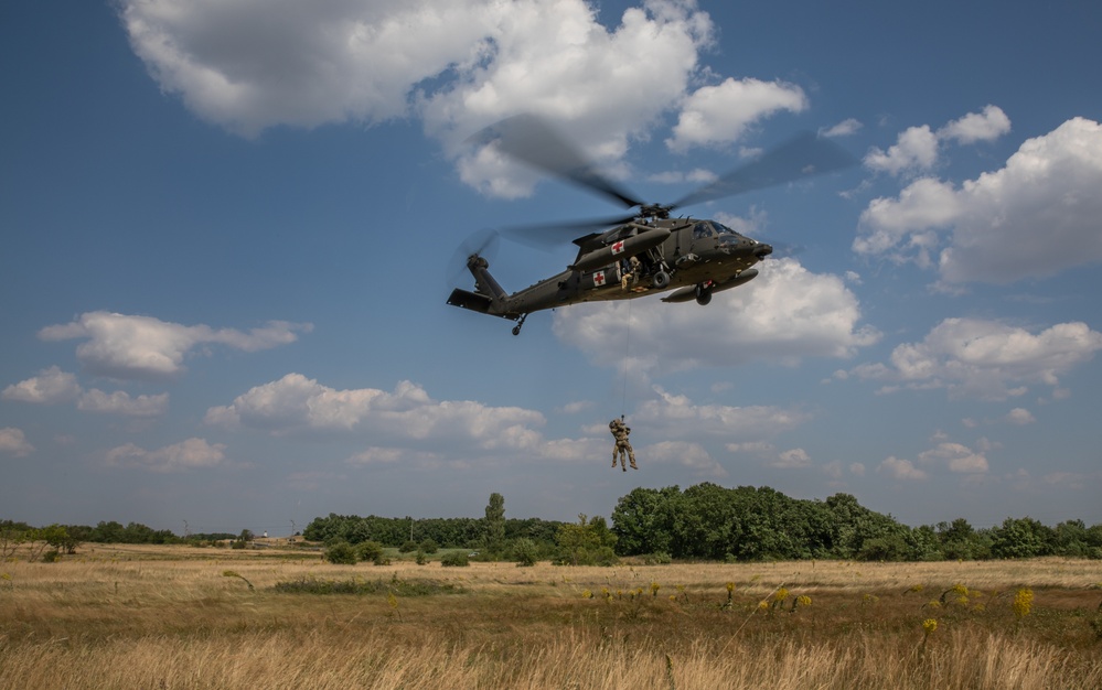 12th Combat Aviation Brigade Soldiers conduct MEDEVAC hoist training with a UH-60 Black Hawk helicopter