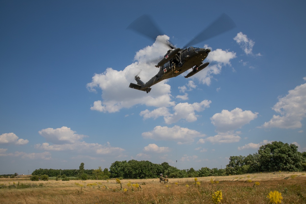 12th Combat Aviation Brigade Soldiers conduct MEDEVAC hoist training with a UH-60 Black Hawk helicopter