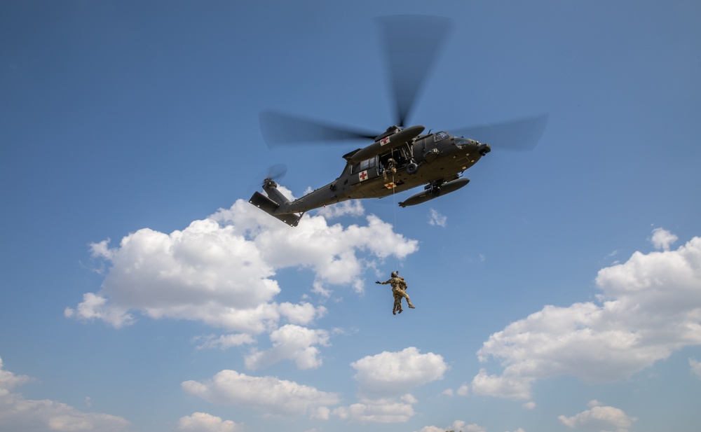 12th Combat Aviation Brigade Soldiers conduct MEDEVAC hoist training with a UH-60 Black Hawk helicopter