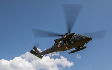 12th Combat Aviation Brigade Soldiers conduct MEDEVAC hoist training with a UH-60 Black Hawk helicopter