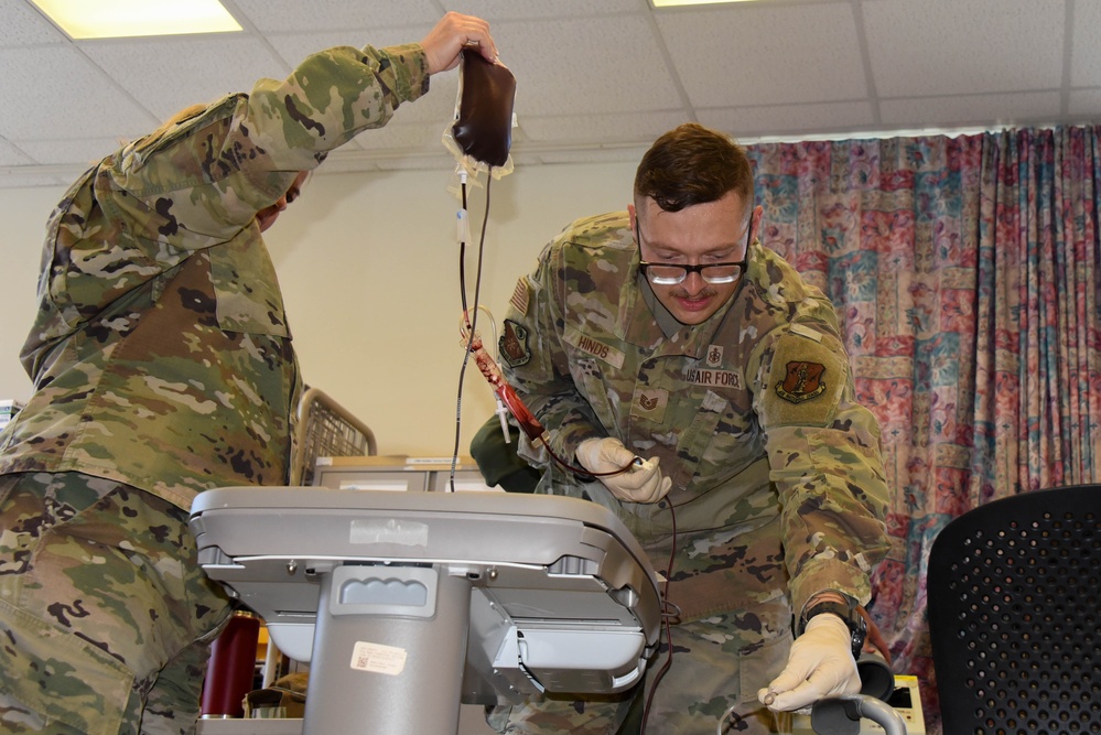 Tech Sgt. Dylan Hinds performs blood transfusion