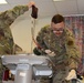 Tech Sgt. Dylan Hinds performs blood transfusion