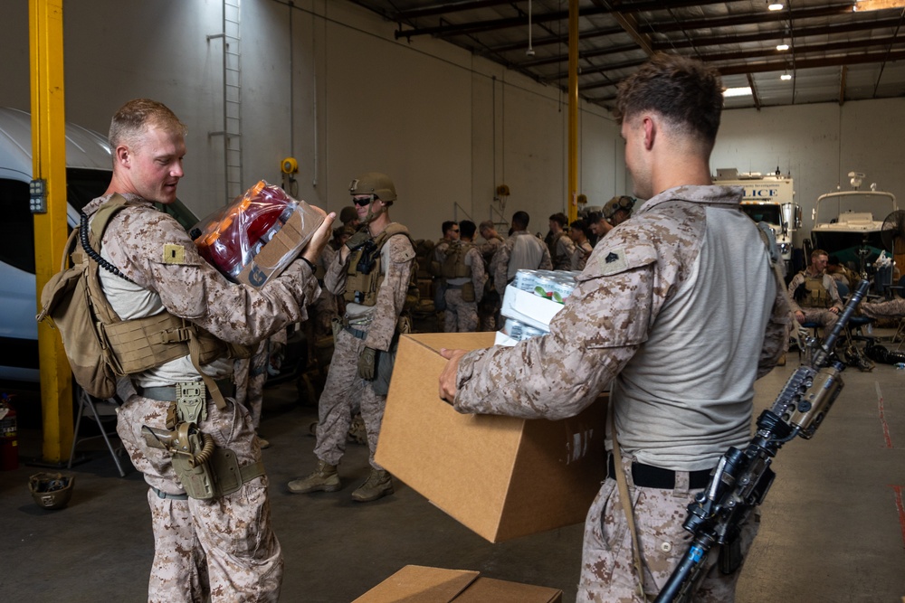 U.S. Marines distribute food delivered by California Army National Guard