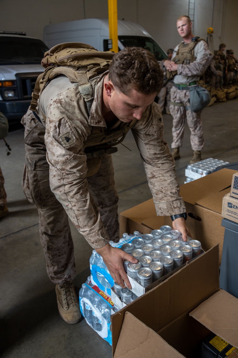 U.S. Marines distribute food delivered by California Army National Guard