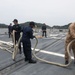 Sailors aboard the USS John Finn conduct a sea and anchor detail in Yokosuka, Japan