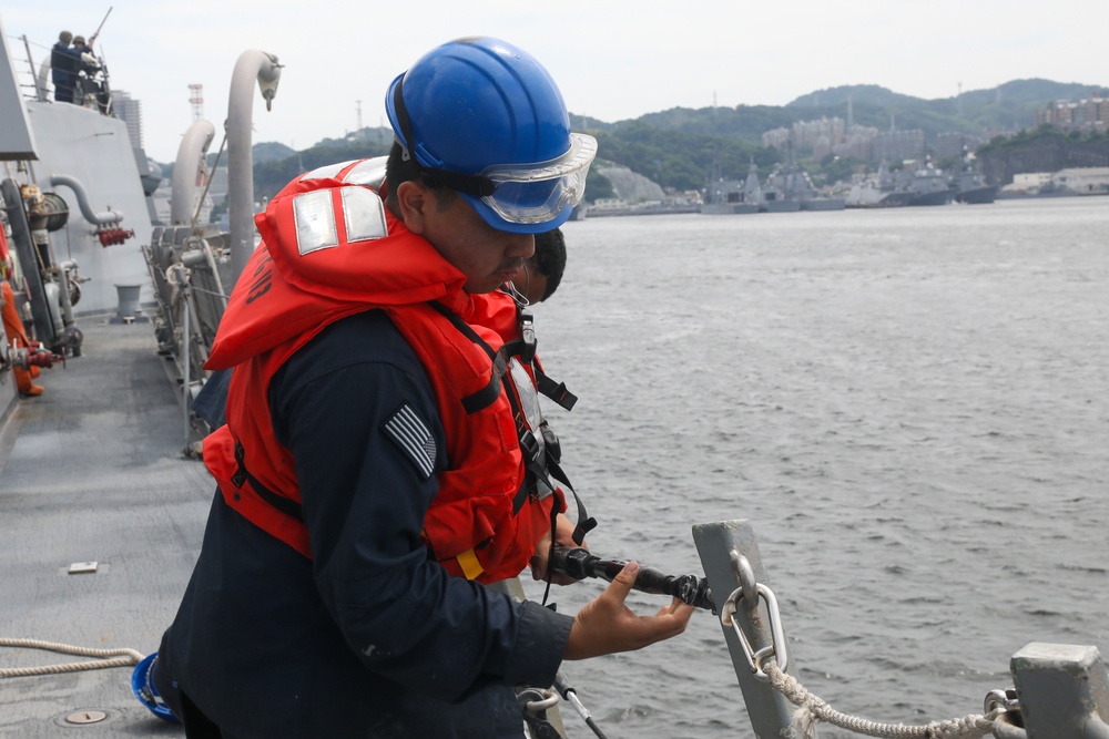 Sailors aboard the USS John Finn conduct a sea and anchor detail in Yokosuka, Japan