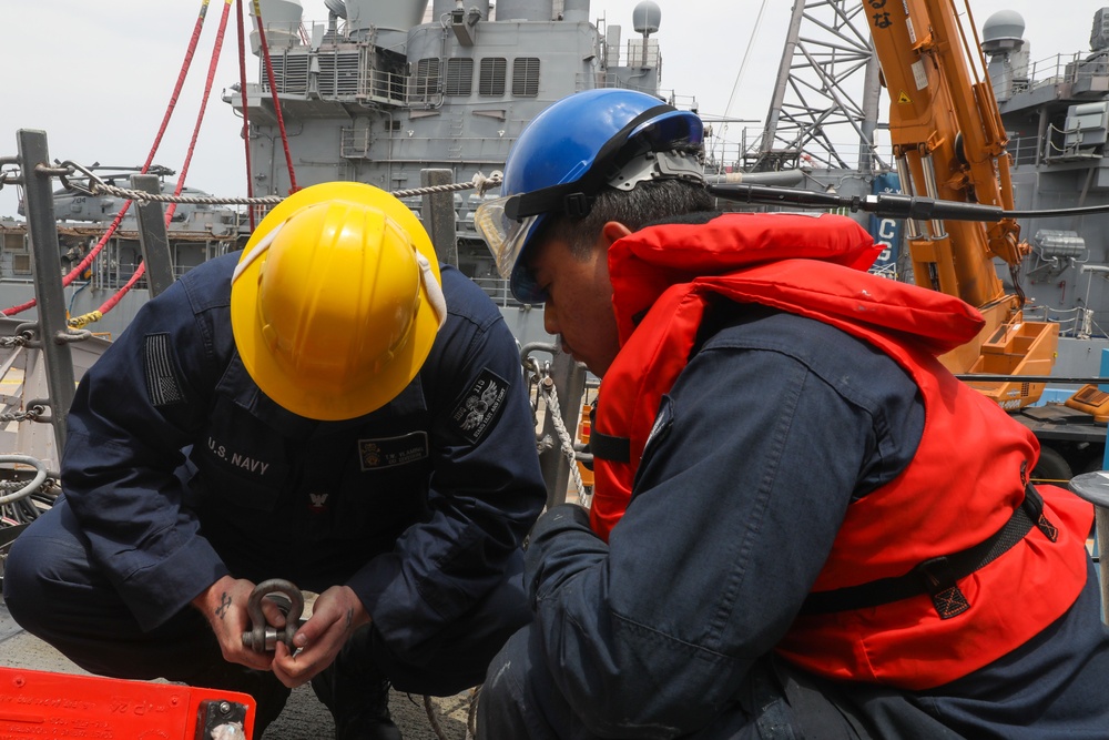 Sailors aboard the USS John Finn conduct a sea and anchor detail in Yokosuka, Japan