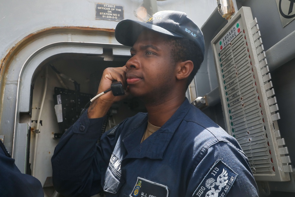 Sailors aboard the USS John Finn conduct a sea and anchor detail in Yokosuka, Japan