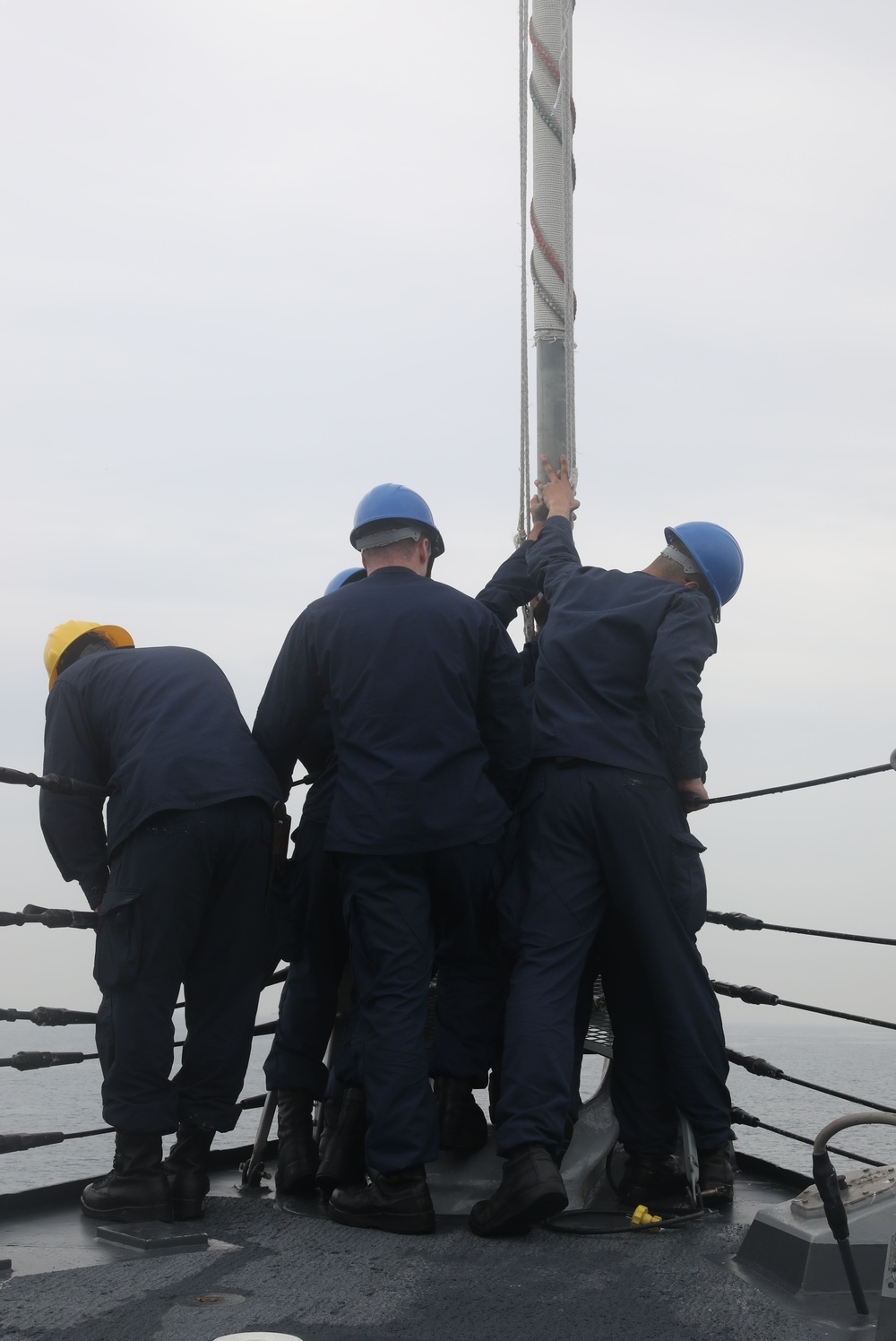 Sailors aboard the USS John Finn conduct a sea and anchor detail in Yokosuka, Japan