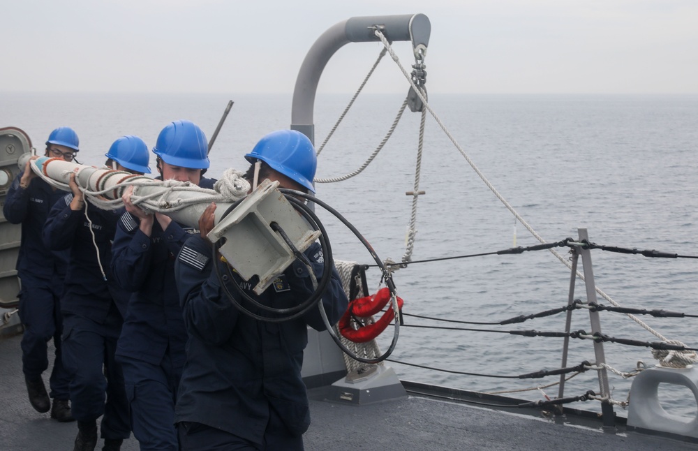 Sailors aboard the USS John Finn conduct a sea and anchor detail in Yokosuka, Japan