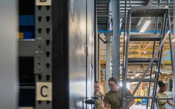 Airmen sort and organize incoming shipments