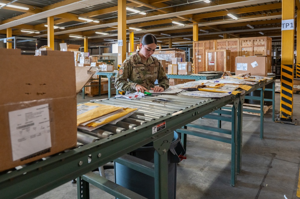 Airmen sort and organize incoming shipments