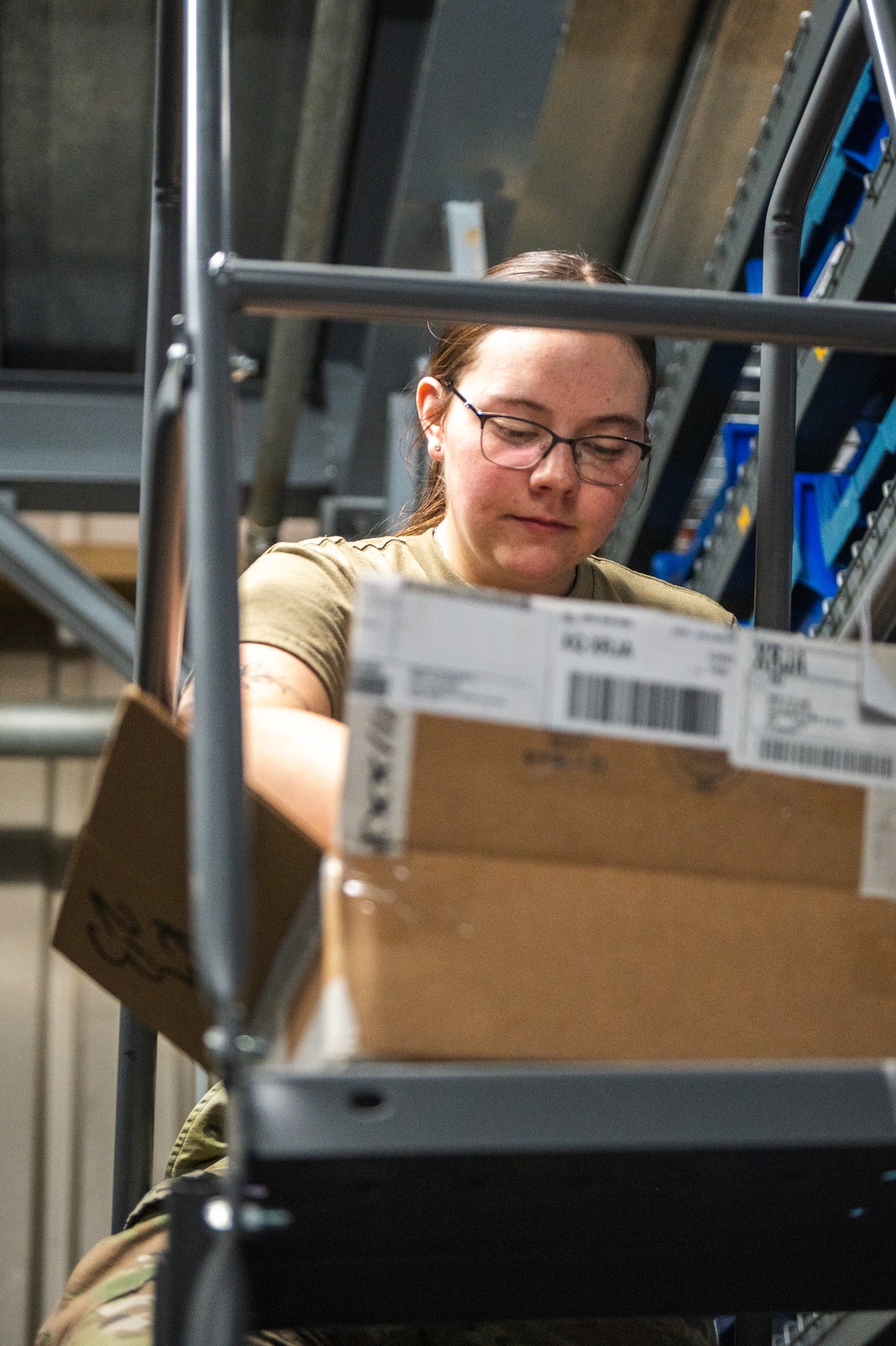 Airmen sort and organize incoming shipments