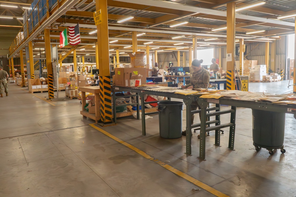 Airmen sort and organize incoming shipments