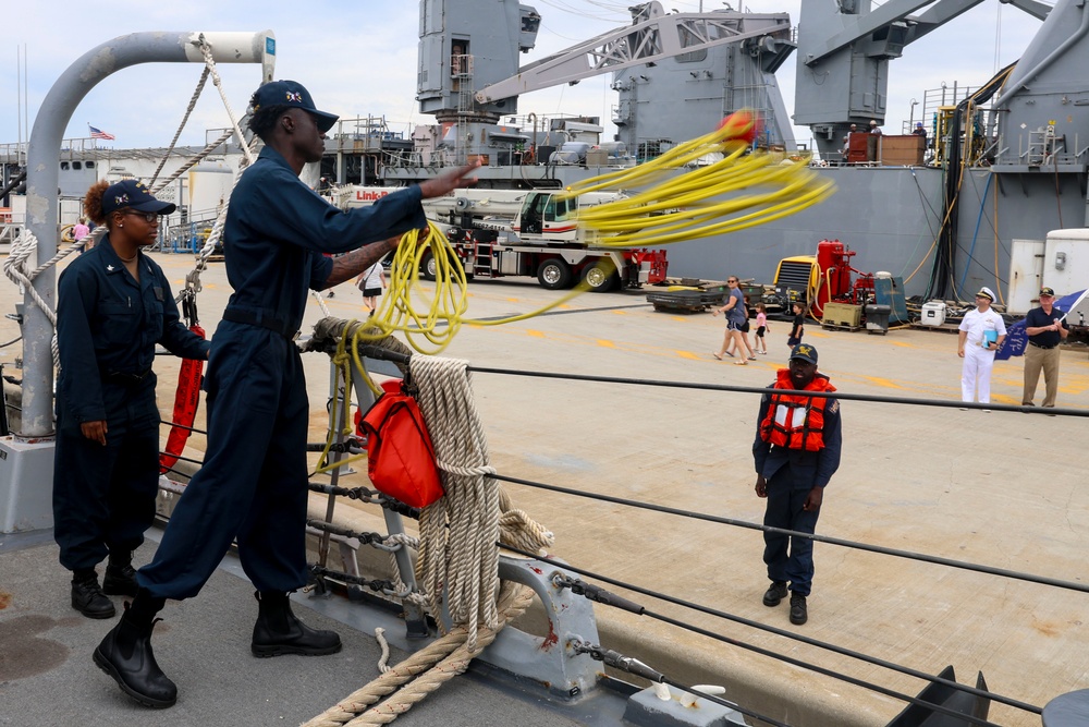 SN Samuel Ofori heaves a mooring line from the ship to the pier