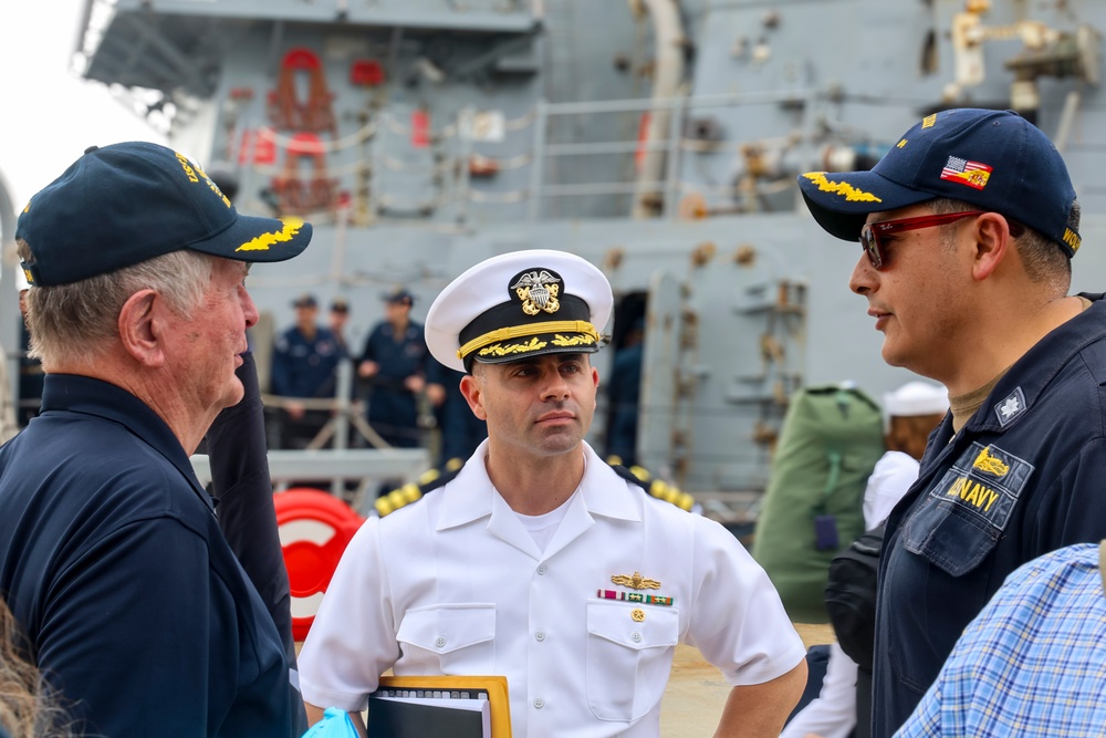 Commanding Officer Cmdr. Arturo Trejo meets with prospective Executive Officer Cmdr. Anthony LaVopa and Retired U.S. Navy Capt. Peter Bulkeley