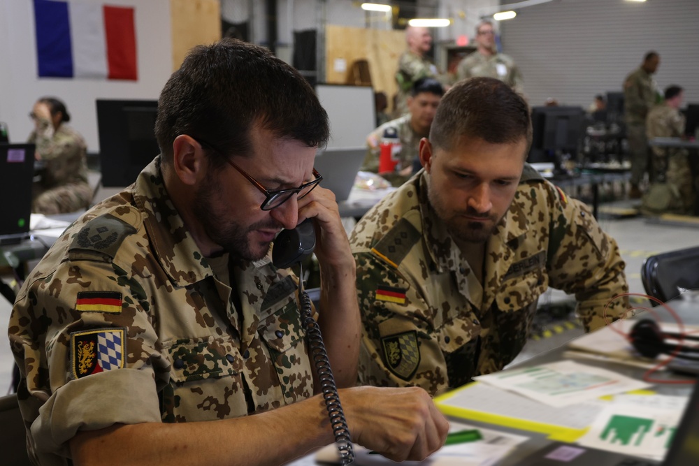 German Army liaison officer communicates by telephone with a colleague at the Main Command Post during Warfighter Exercise 25-4.