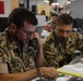 German Army liaison officer communicates by telephone with a colleague at the Main Command Post during Warfighter Exercise 25-4.