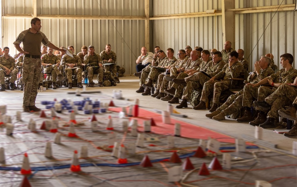 Members of 3rd United Kingdom Division conduct a rehearsal of concept drill during Warfighter Exercise 25-4