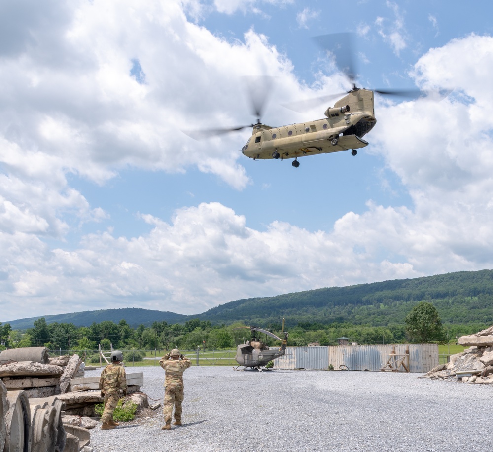 28th ECAB airlifts decommissioned Huey from mountaintop