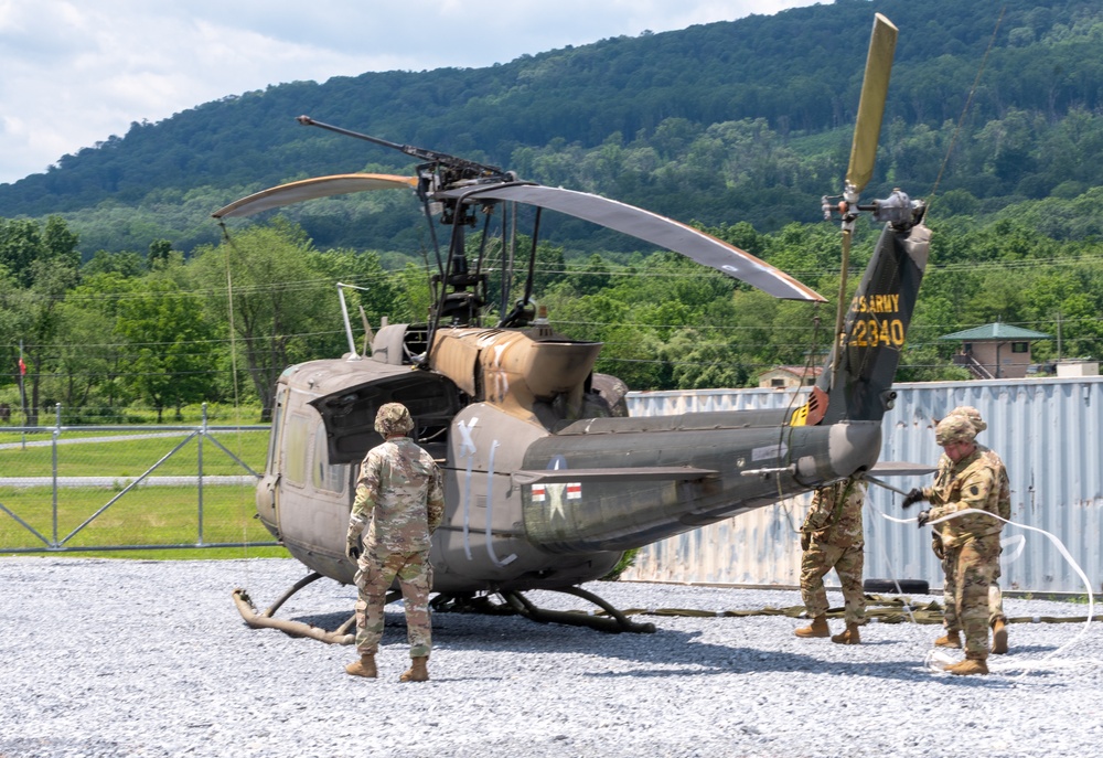 28th ECAB airlifts decommissioned Huey from mountaintop