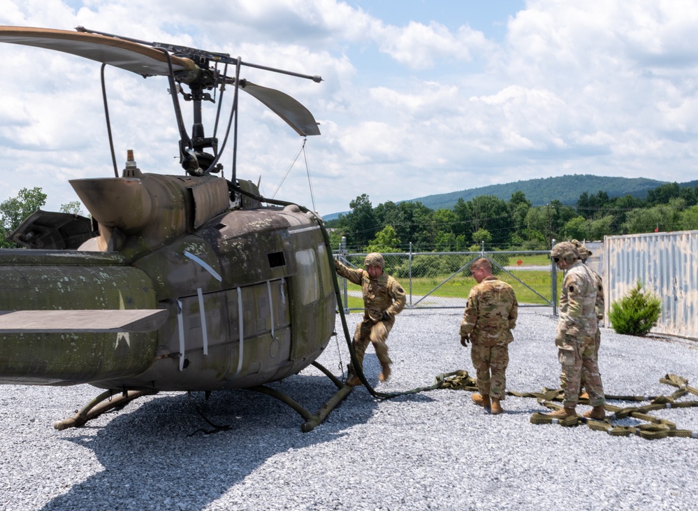 28th ECAB airlifts decommissioned Huey from mountaintop