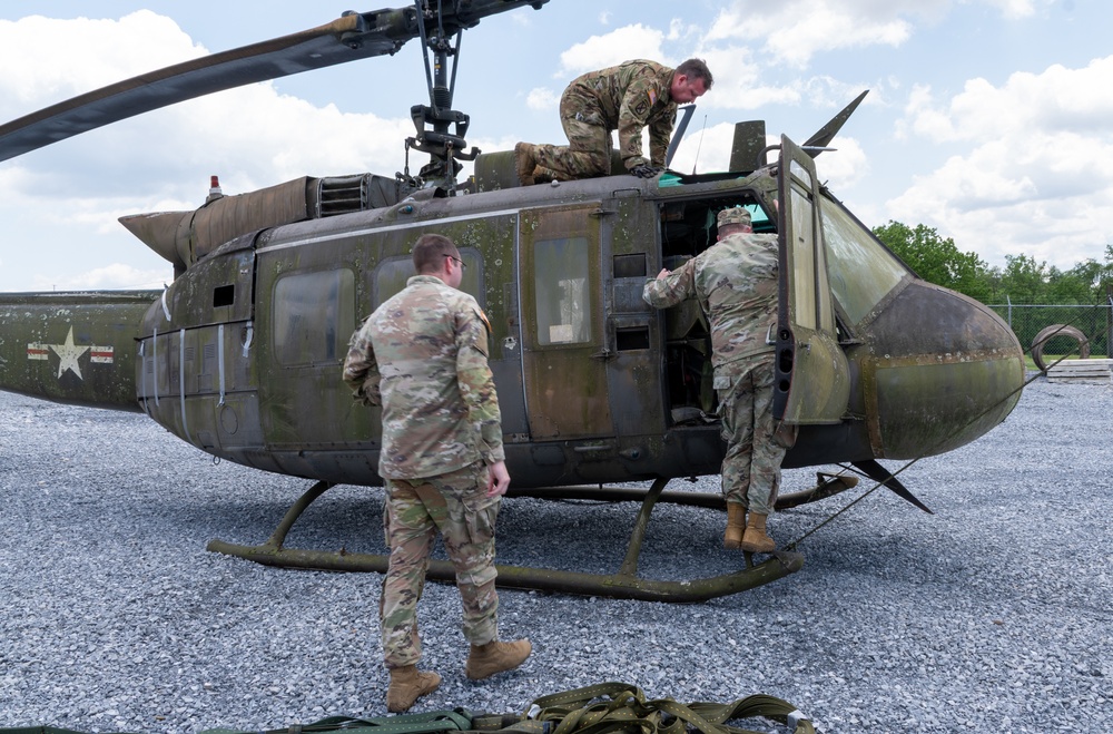 28th ECAB airlifts decommissioned Huey from mountaintop