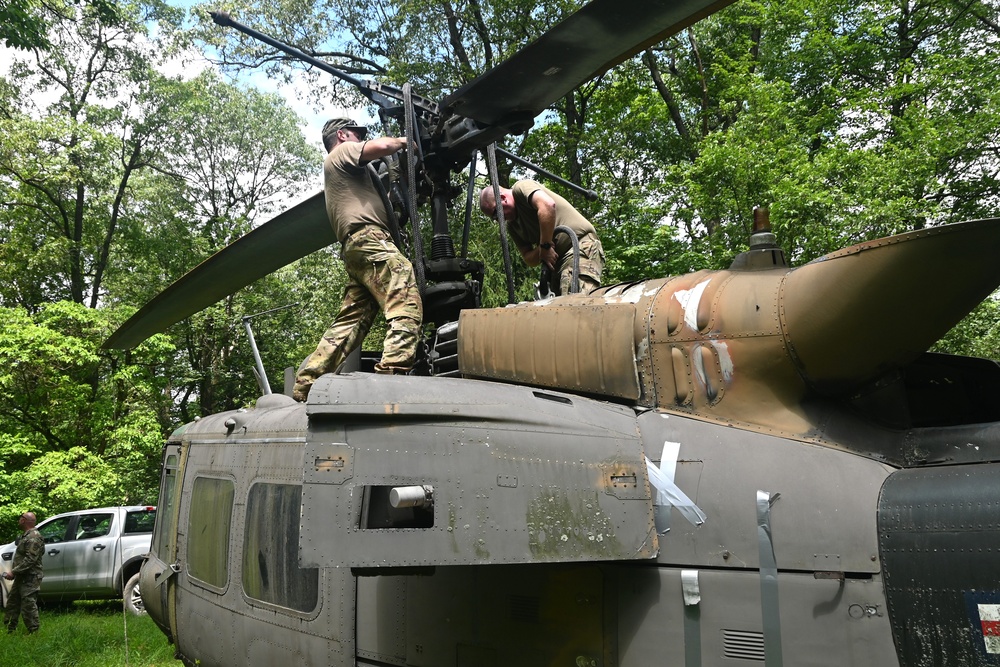 28th ECAB airlifts decommissioned Huey from mountaintop