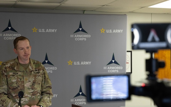U.S. Army Maj. Brent Green, talks with mock press during Warfighter 25-4